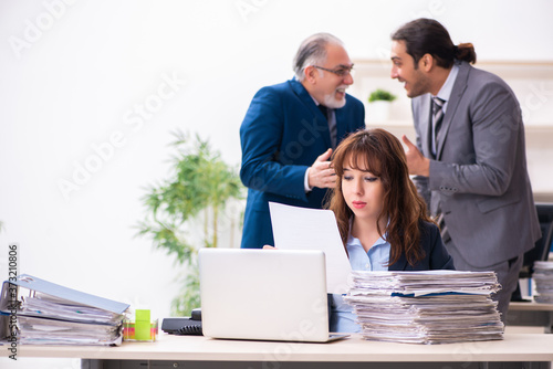 Two male and one female employees working in the office