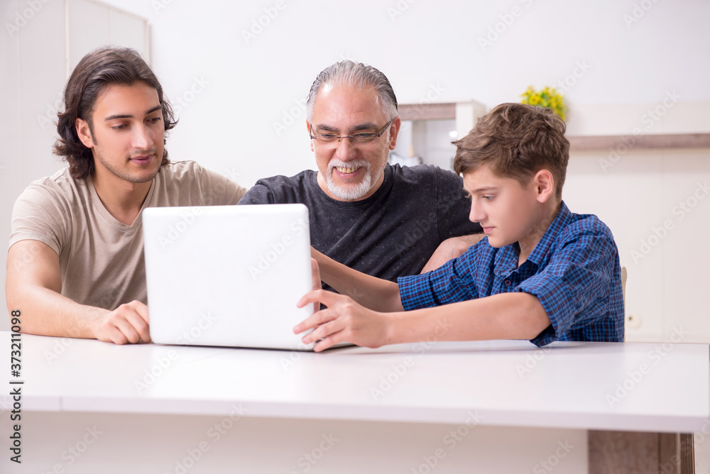 Grandfather learning new technology from son and grandson Grandfather learning new technology from son and grandson