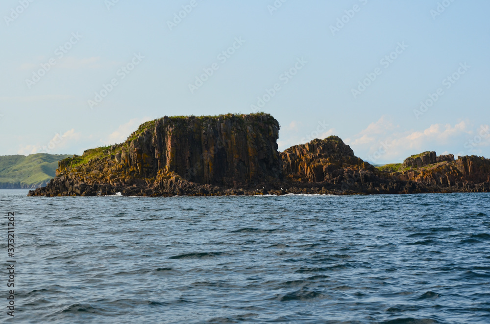 A rock protruding from the sea or rock over the sea A rock protruding from the sea or rock over the sea