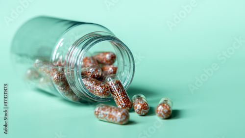 Capsule multivitamins and supplements with fresh and healthy fruits on green background, Close up vitamins and supplements with bottle, Including vitamin pills for healthy eyes.