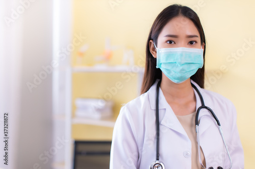 Medicine and health care concept.  Asian doctor  woman in hospital.doctor or nurse wear protection mask checking and takecare infection people from covid-19 .