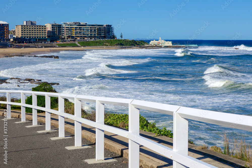 Fototapeta premium White fence looking at the Newcastle beach, NSW, Australia.