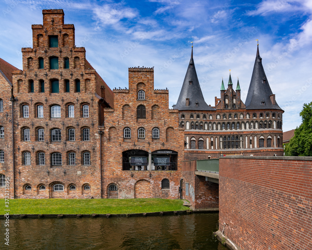 historic red brick buildings and the Holstentor city gate in Luebeck