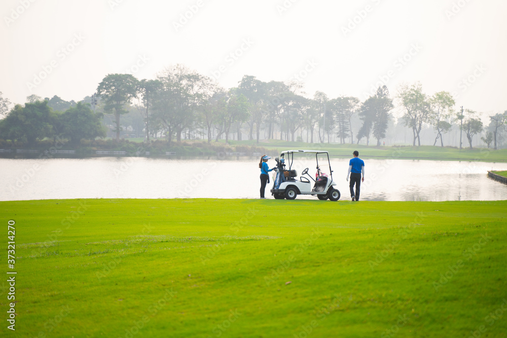 Golfers are about to play golf on bright green grass Golfers are about to play golf on bright green grass