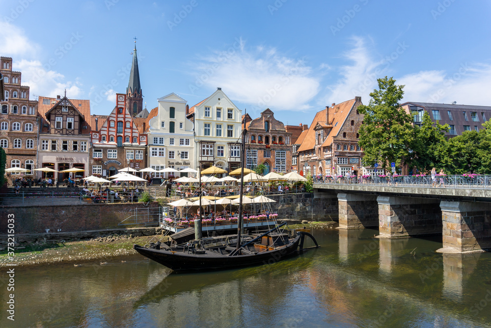 view of the river and the historic old city center of Luneburg in northern Germany