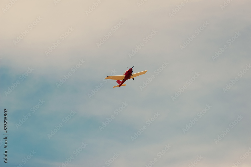 Photo of small airplane flying in a beautiful clean summer day.