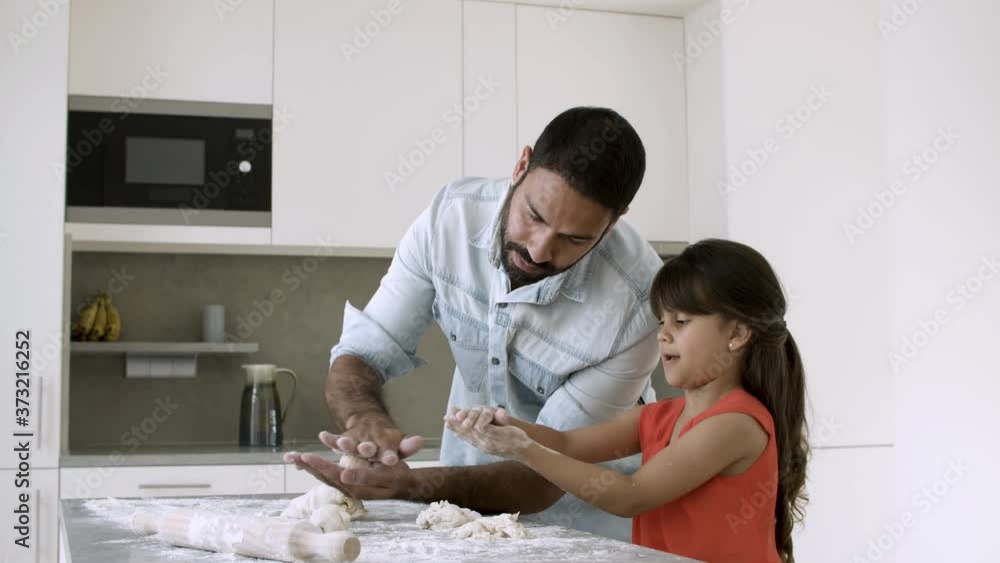 custom made wallpaper toronto digitalHappy focused dad teaching daughter to bake, kneading dough on kitchen table with flour messy and making balls. Medium shot. Family cooking at home concept