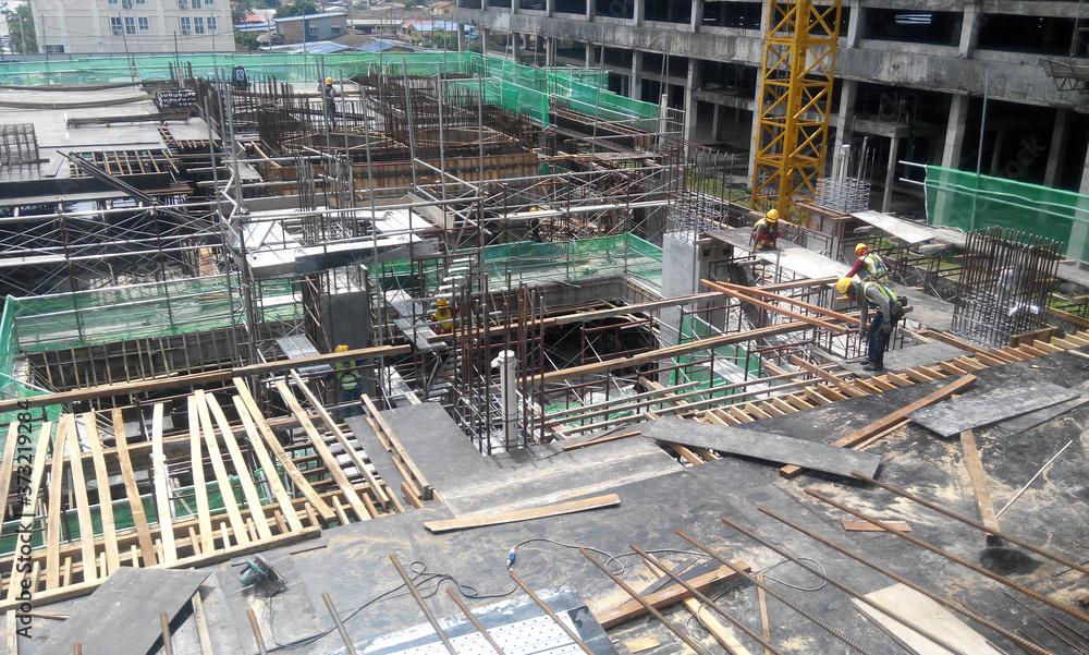 
KUALA LUMPUR, MALAYSIA -MARCH 05, 2020: Construction workers installing & fabricating timber formwork at the construction site. The formworks made from timber and plywood. 