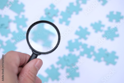 magnifying glass and puzzle