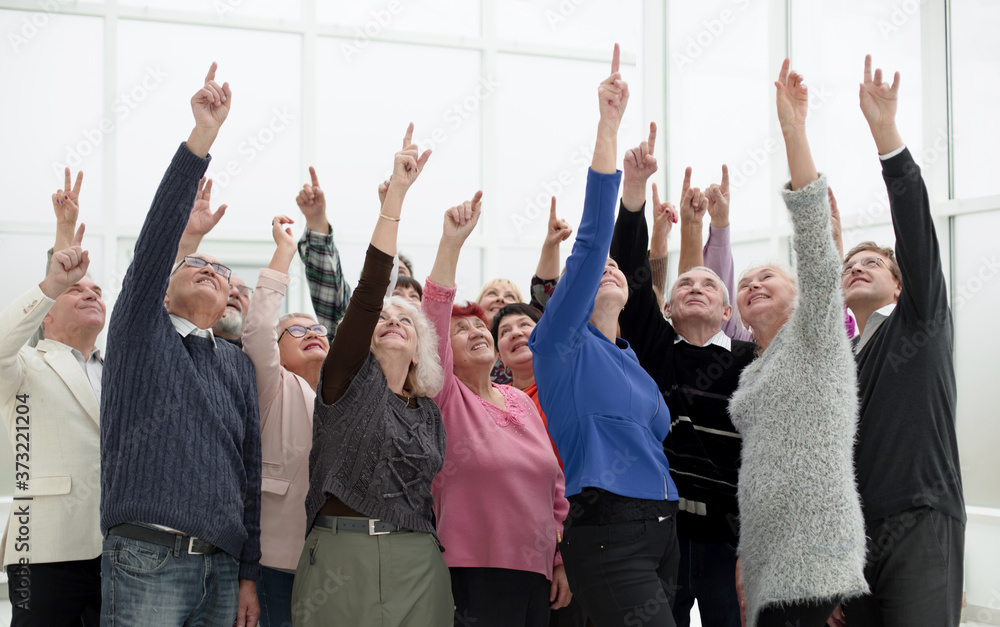 a group of elderly people are reaching up a group of elderly people are reaching up