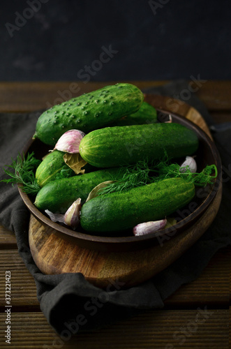 Fresh cucumbers with herbs on plate