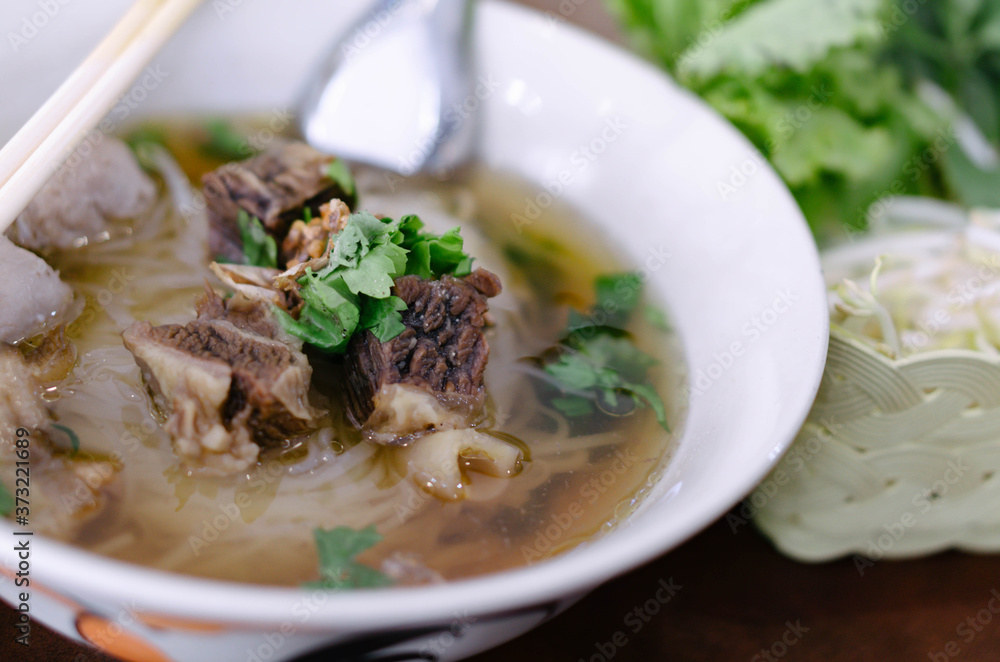 Rice noodle soup with Cooked Liver in bowl on table, selective focus Rice noodle soup with Cooked Liver in bowl on table, selective focus