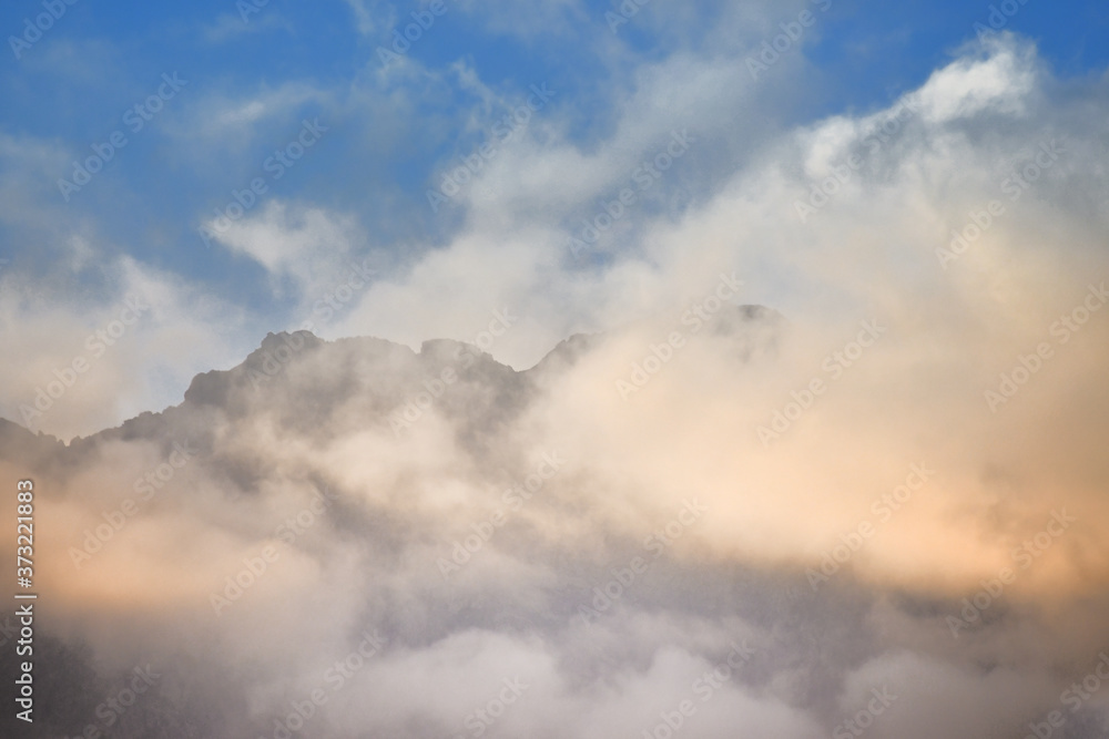 The colorful clouds above the summit of Mount Mars in the Biella pre-Alps The colorful clouds above the summit of Mount Mars in the Biella pre-Alps
