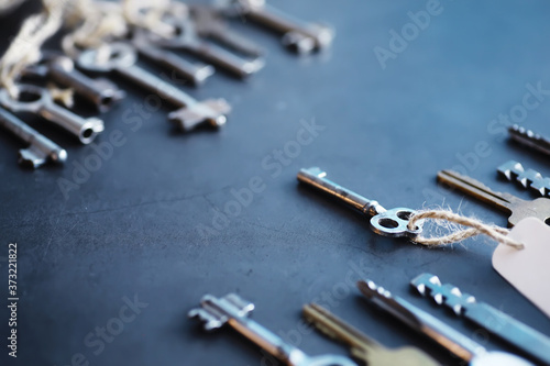Set of vintage keys for a lock. Retro keys on a dark stone background. The concept of choosing the path to achieve the goal. © alexkich