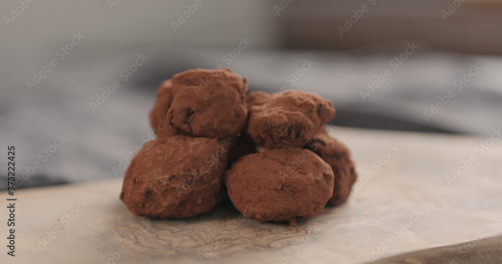 Fototapeta premium handmade chocolate truffles on a wood board