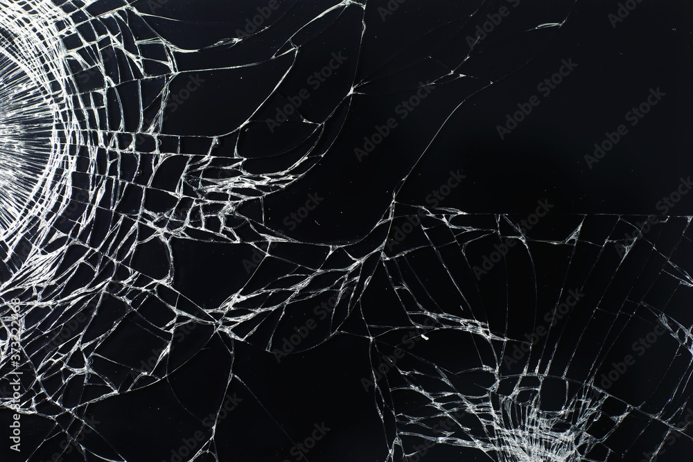 Crack on the glass. Broken screen. Broken phone. Cracked glass background. White cracks in the glass. Crack on the glass. Broken screen. Broken phone. Cracked glass background. White cracks in the glass.