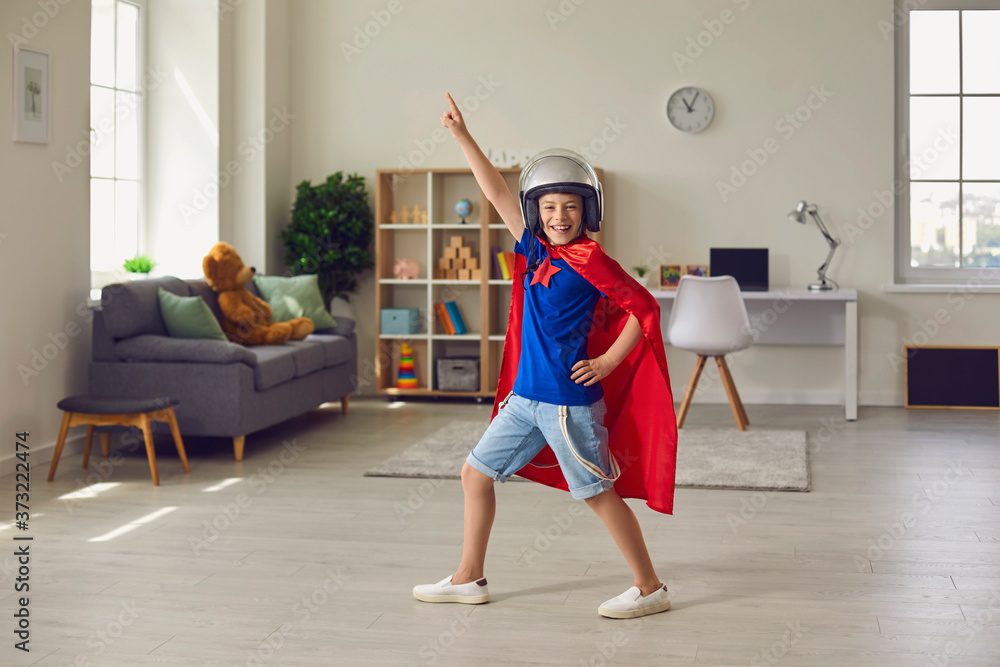 Boy hero in pilots costume and helmet playing role of superhero at home Boy hero in pilots costume and helmet playing role of superhero at home