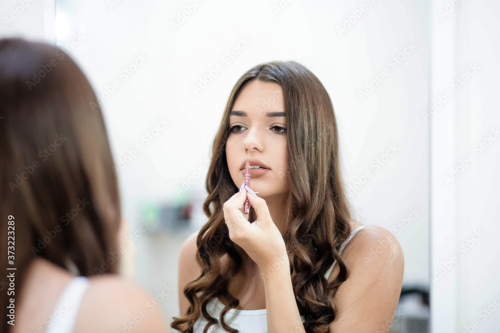 Young sexy beautiful sexy woman doing makeup in the mirror, mascara. The girl is doing makeup in the mirror. Young sexy beautiful sexy woman doing makeup in the mirror, mascara. The girl is doing makeup in the mirror.