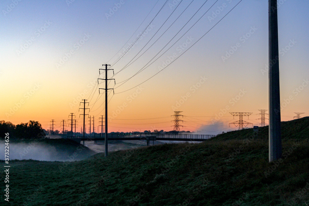 Foggy sunrise powerlines