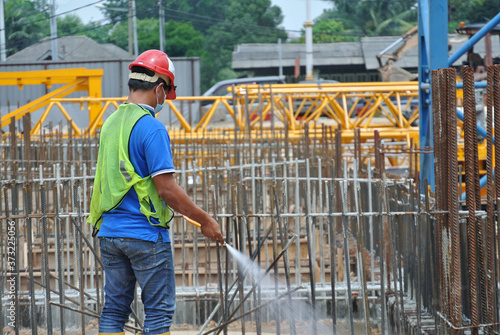 JOHOR, MALAYSIA -MARCH 29, 2016: Construction workers spraying the anti termite chemical treatment to the soil at the construction site.  © Aisyaqilumar