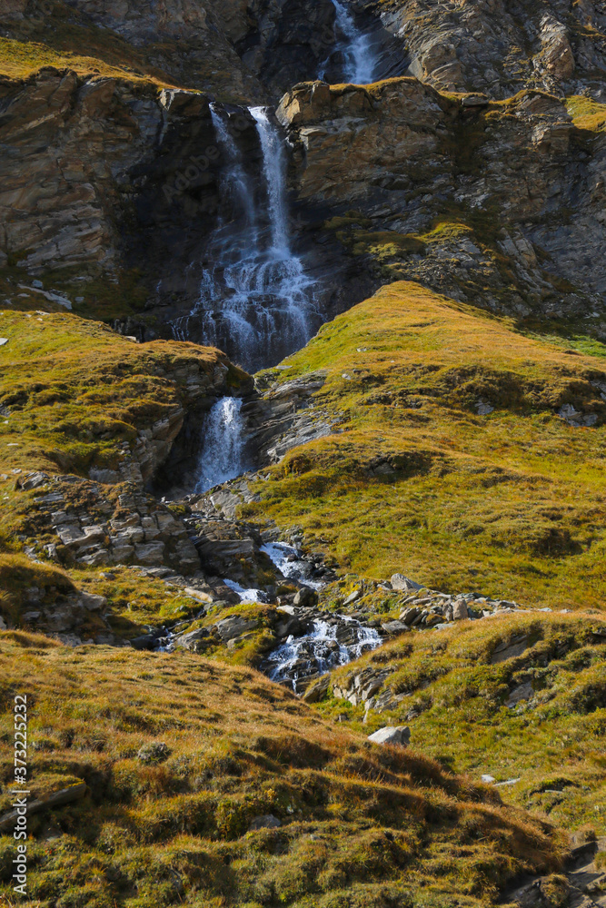 A small mountain stream flows down the mountainside. A small mountain stream flows down the mountainside.