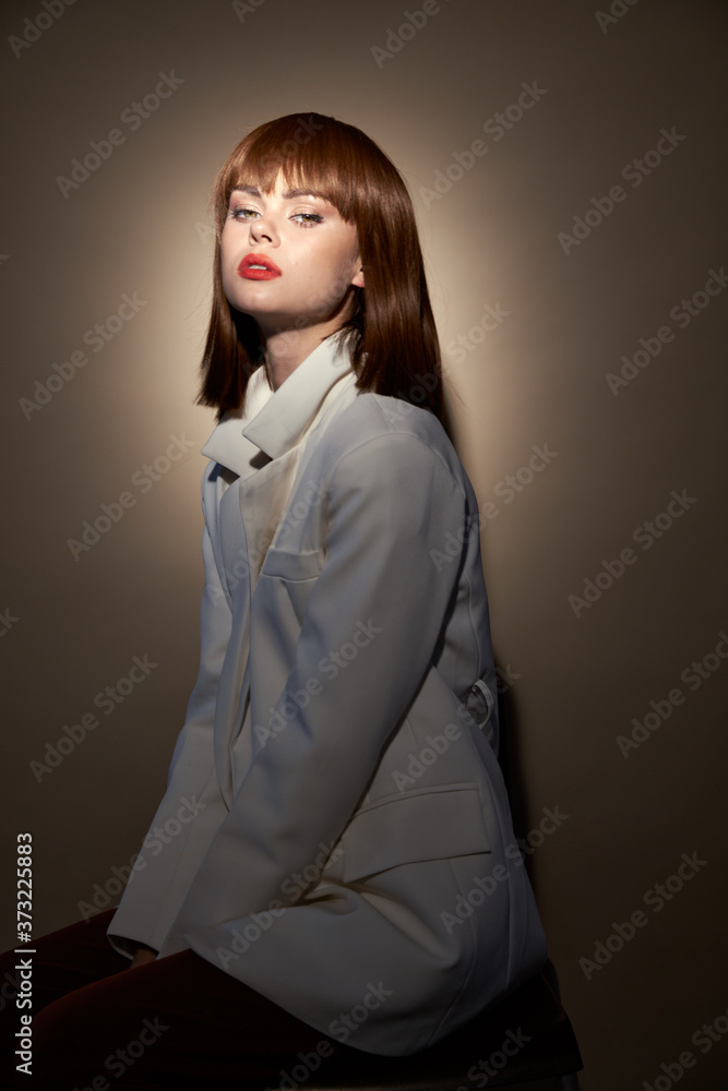 Charming woman in light coat pose for the camera Charming woman in light coat pose for the camera