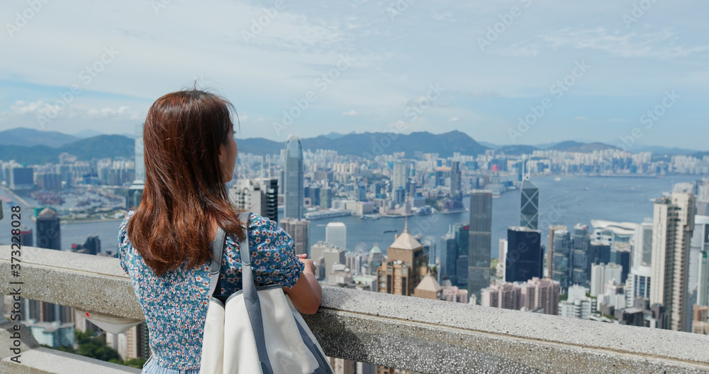 Woman visit Hong Kong, enjoy the city view