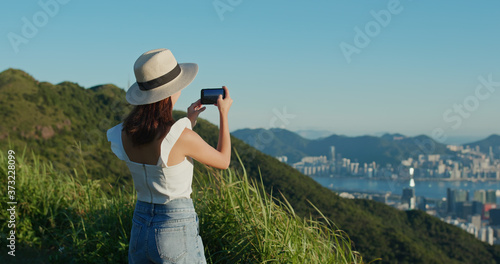 Photography Woman look at the beautiful city view from top