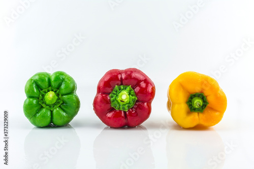 Sweet pepper on a white background./ Three colorful fresh yellow, red, green sweet pepper.