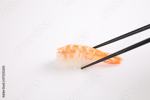 Shrimp sushi with chopsticks Japanese food isolated in white background