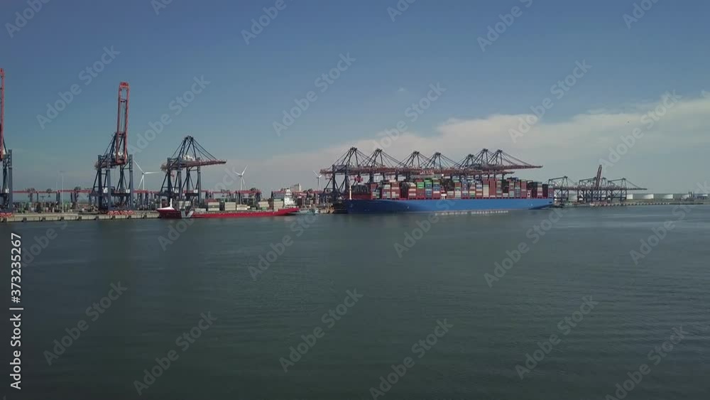 Ship with containers in the harbor of Rotterdam in the Netherlands Ship with containers in the harbor of Rotterdam in the Netherlands