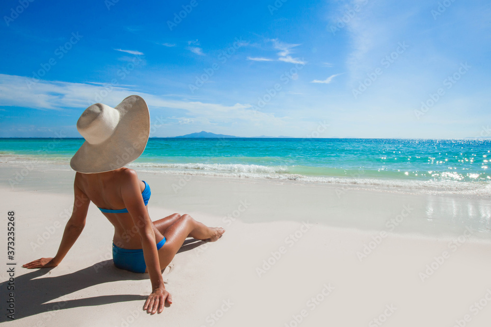 Fototapeta premium Woman on beach looking at sea