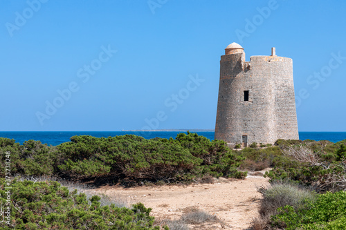 View of the old observation tower Torre De Ses Portes on the coast of the Ibiza island. photo