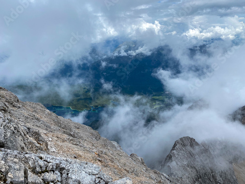 Man Hiking to the top of Germany with a stunning view to the alpine rocks in Germany