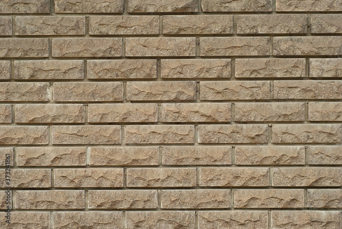 exture of brick wall. new brickwork. Samples of wall or fence are presented at exhibitions. Brown brick close up.