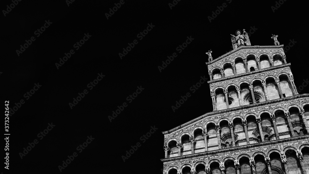 Romanesque architecture in Tuscany. St Micheal in Foro Church beautiful medieval facade in the city of Lucca, Tuscany, erected in the 13th century (Black and White with copy space)