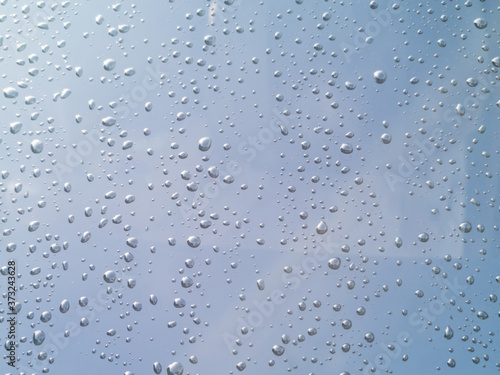 Rain drops on car window glasses surface. Natural Pattern of raindrops.