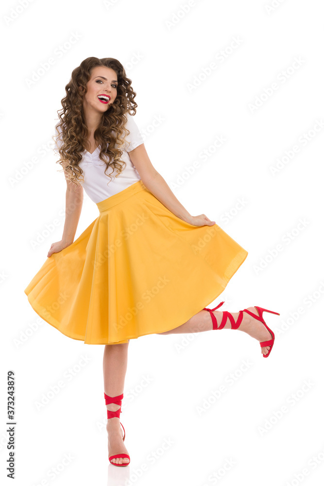 Carefree Woman Is Dancing In Yellow Skirt And Red High Heels. Carefree Woman Is Dancing In Yellow Skirt And Red High Heels.