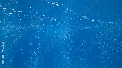 Fethiye, Turkey - 30th of July 2020: 4K Millions of air bubbles rising and meeting surface as shot underwater
