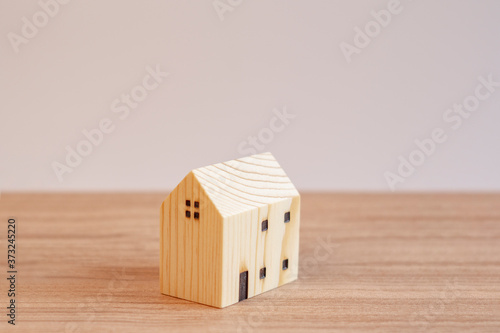 Model wooden hone on wooden table with white background.