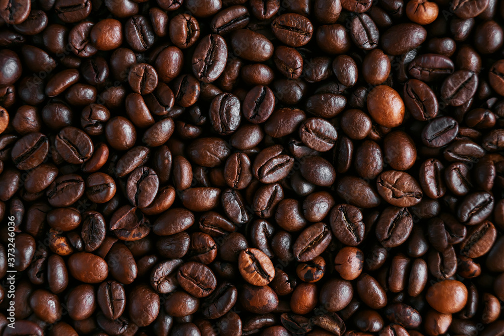 Background of roasted dark aromatic coffee beans, which make an invigorating coffee drink. The view from the top. Background of roasted dark aromatic coffee beans, which make an invigorating coffee drink. The view from the top.