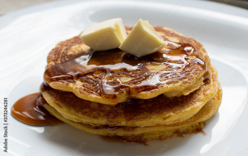 Pancakes stacked with honey and butter