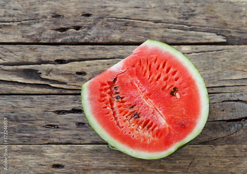Red watermelon on a wooden rustic table. Food background.