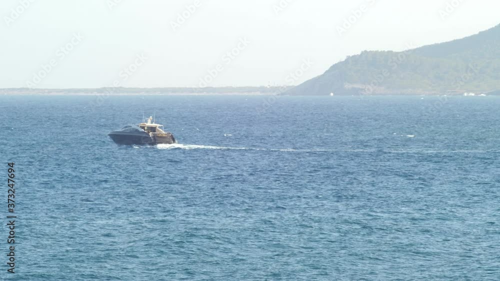 Isolated Yacht Sailing on the Ocean Waves, Island Background Long Shot Isolated Yacht Sailing on the Ocean Waves, Island Background Long Shot