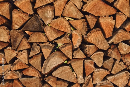 Stacks of firewood in the sawmill. Pile of firewood. Firewood wall. Wood pattern.