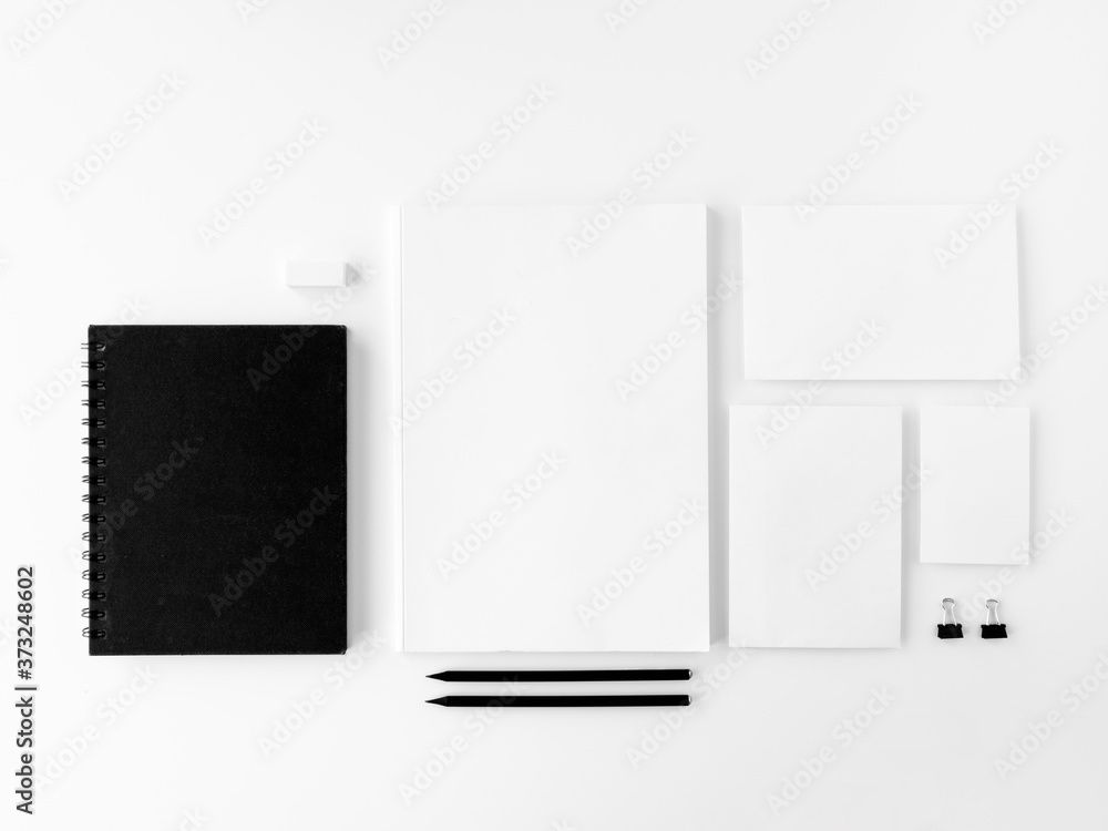 Blank stationery set mockup. Corporate identity template. Copy space for branding identity. Top view, covers, notepads, and business card over white desk Blank stationery set mockup. Corporate identity template. Copy space for branding identity. Top view, covers, notepads, and business card over white desk