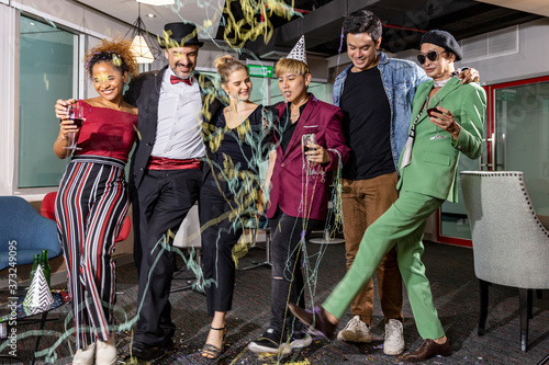 Business workers from different ethnicities celebrate a great achievement after long effort. Business people and members of LGBT work together and enjoy big success in a party