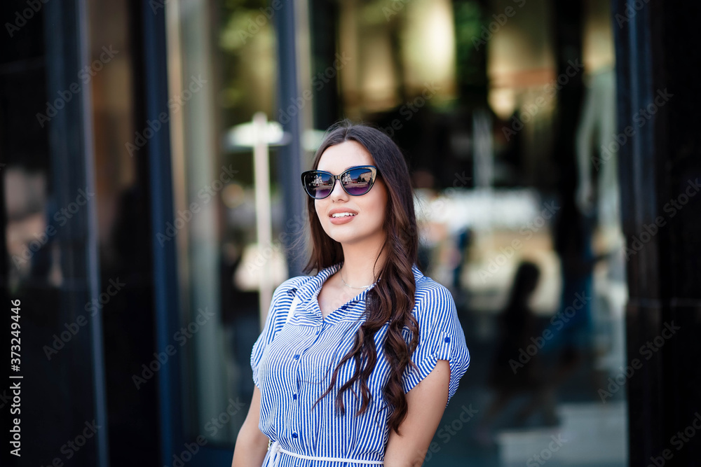 Young cute, crazy, big amazing smile, vintage outfit, sunglasses, staging downtown Europe, cute emotions. Portrait of a girl. Sunglasses on the girl.