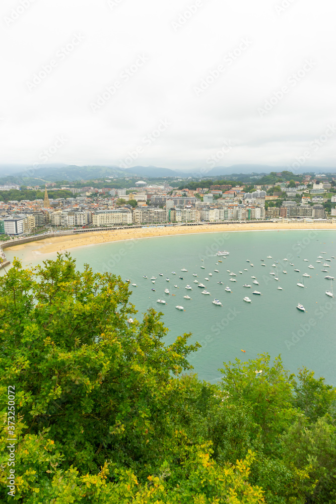 Tourism, view of the city of San Sebastian, with La Concha beach, from Mount Urgull. Summer vacation scene in Spain