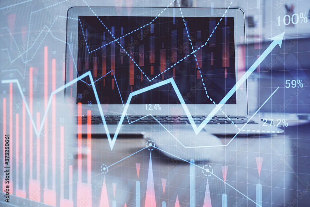 Forex market chart hologram and personal computer background. Multi exposure. Concept of investment. Forex market chart hologram and personal computer background. Multi exposure. Concept of investment.